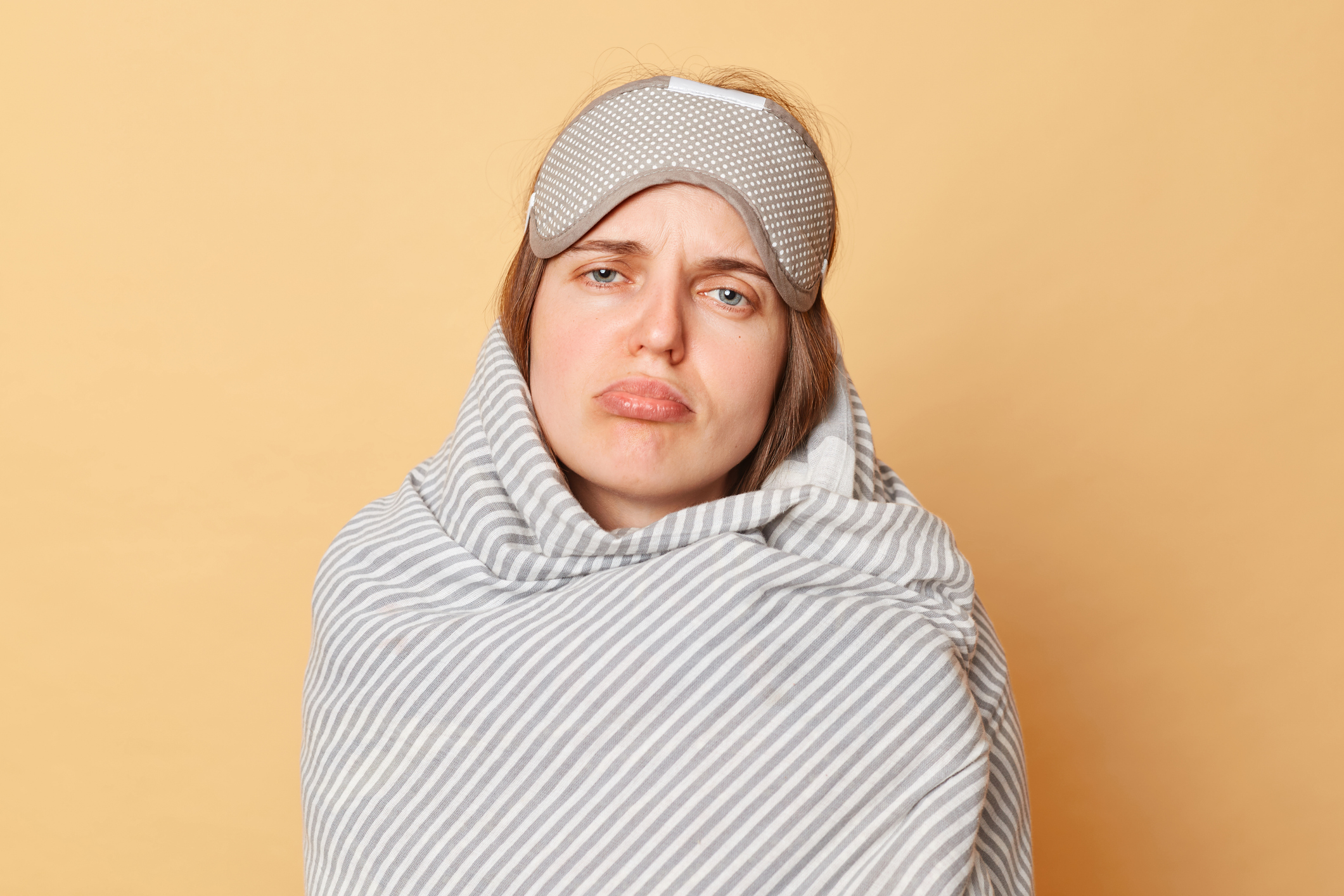 frowning woman wrapped in blanket and sleep mask you snooze, you lose missing student loan forgiveness deadline