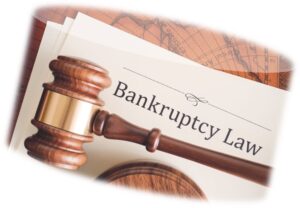 Gavel laying against white document with the words bankruptcy law written on the top of it