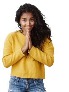 pretty dark skinned young female wearing jeans and yellow sweater with hands pressed together