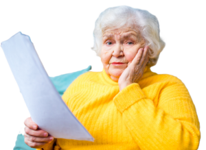 older woman with gray hair wearing a yellow sweater holding a piece of paper looking at he camera with a confused expresion